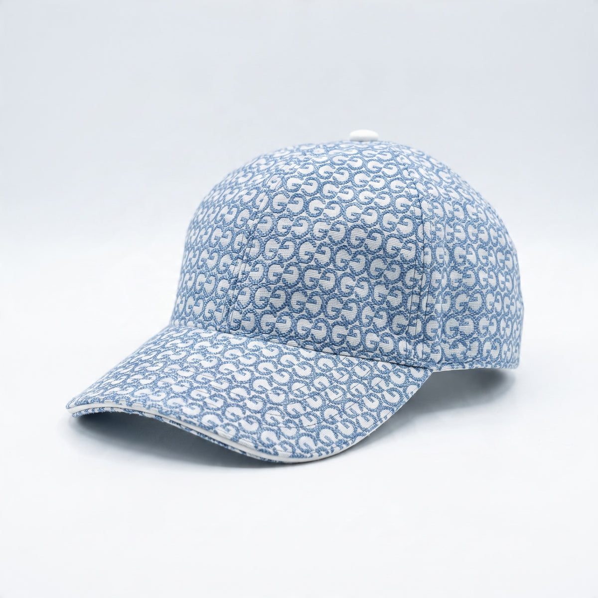 Light blue Gucci monogram baseball cap with curved brim and top button