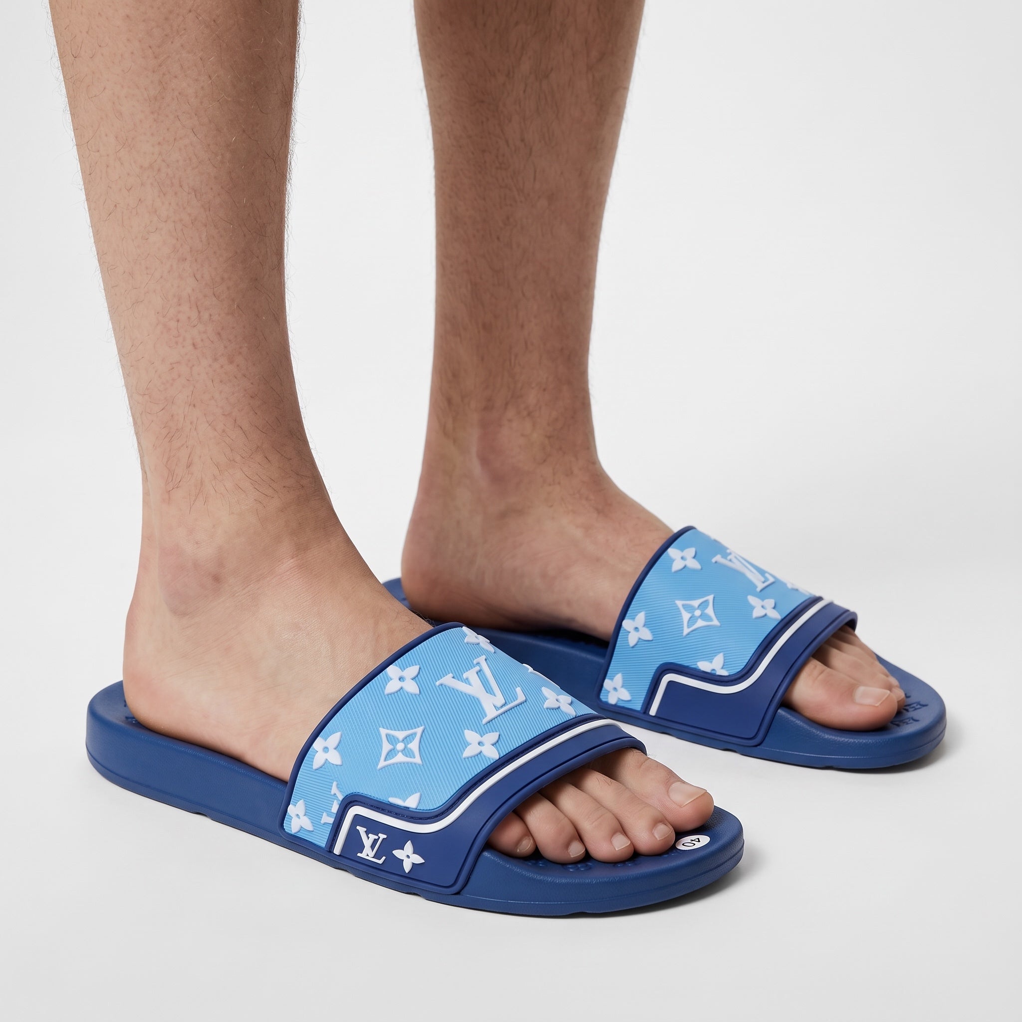 Sky blue Louis Vuitton monogram men's slide sandals on model feet