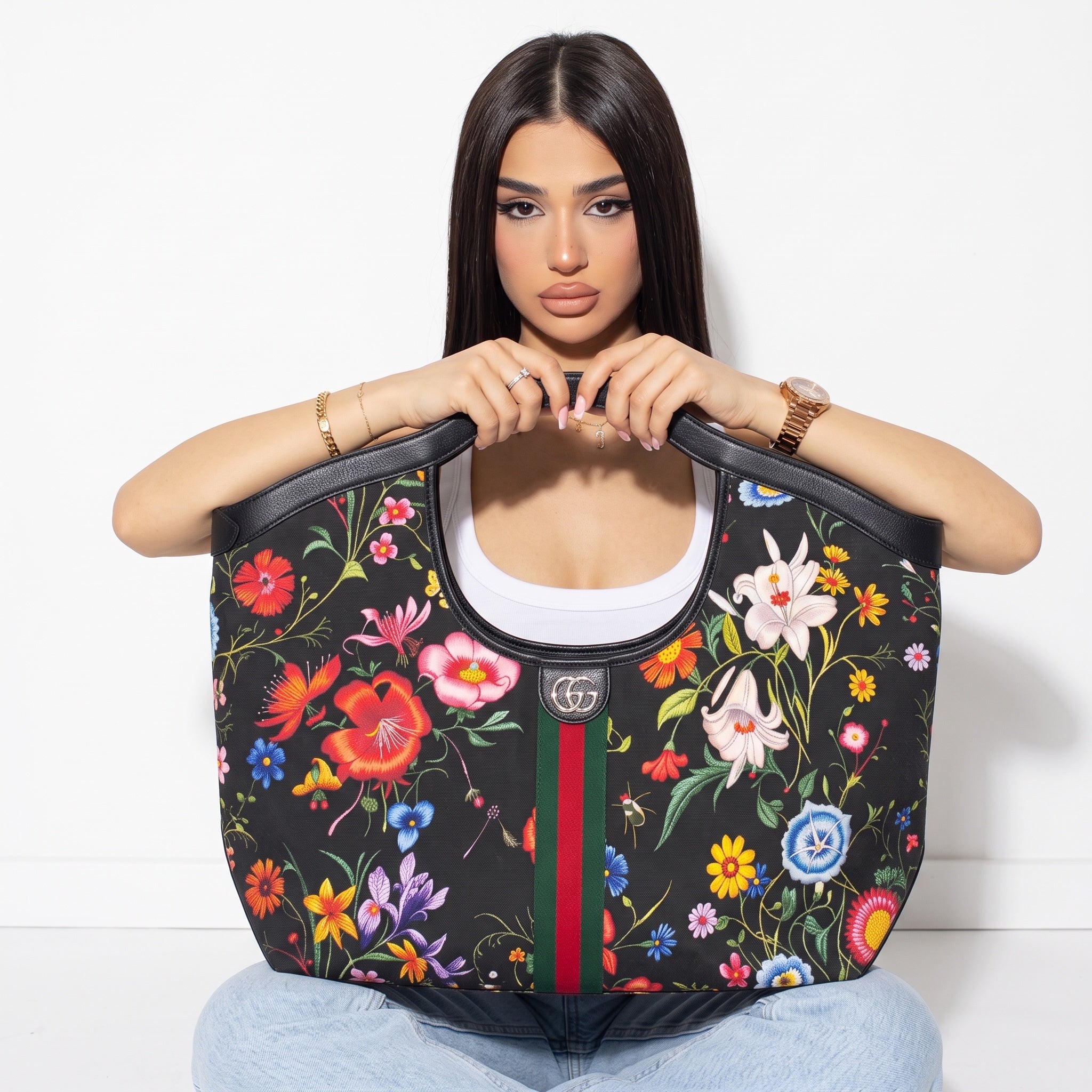 Black Gucci tote with colorful floral print, GG logo and green-red-green stripe