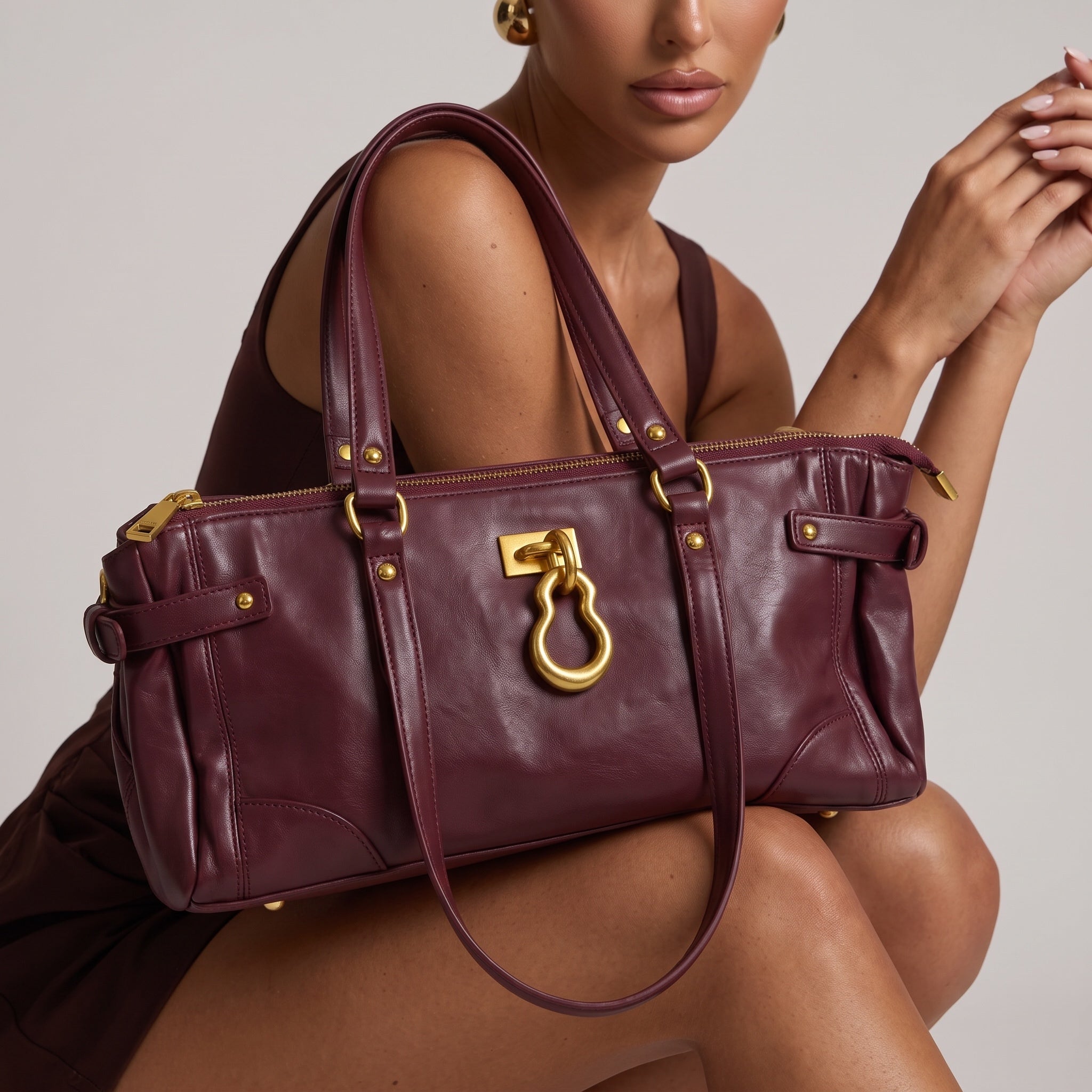 burgundy leather tote bag with gold hardware and double handles