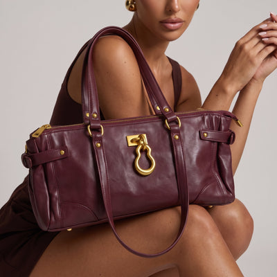 burgundy leather tote bag with gold hardware and double handles