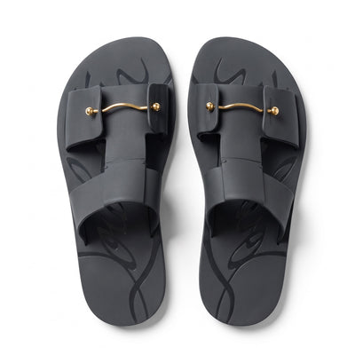 black Christian Louboutin rubber slide with red sole and gold-tone bar