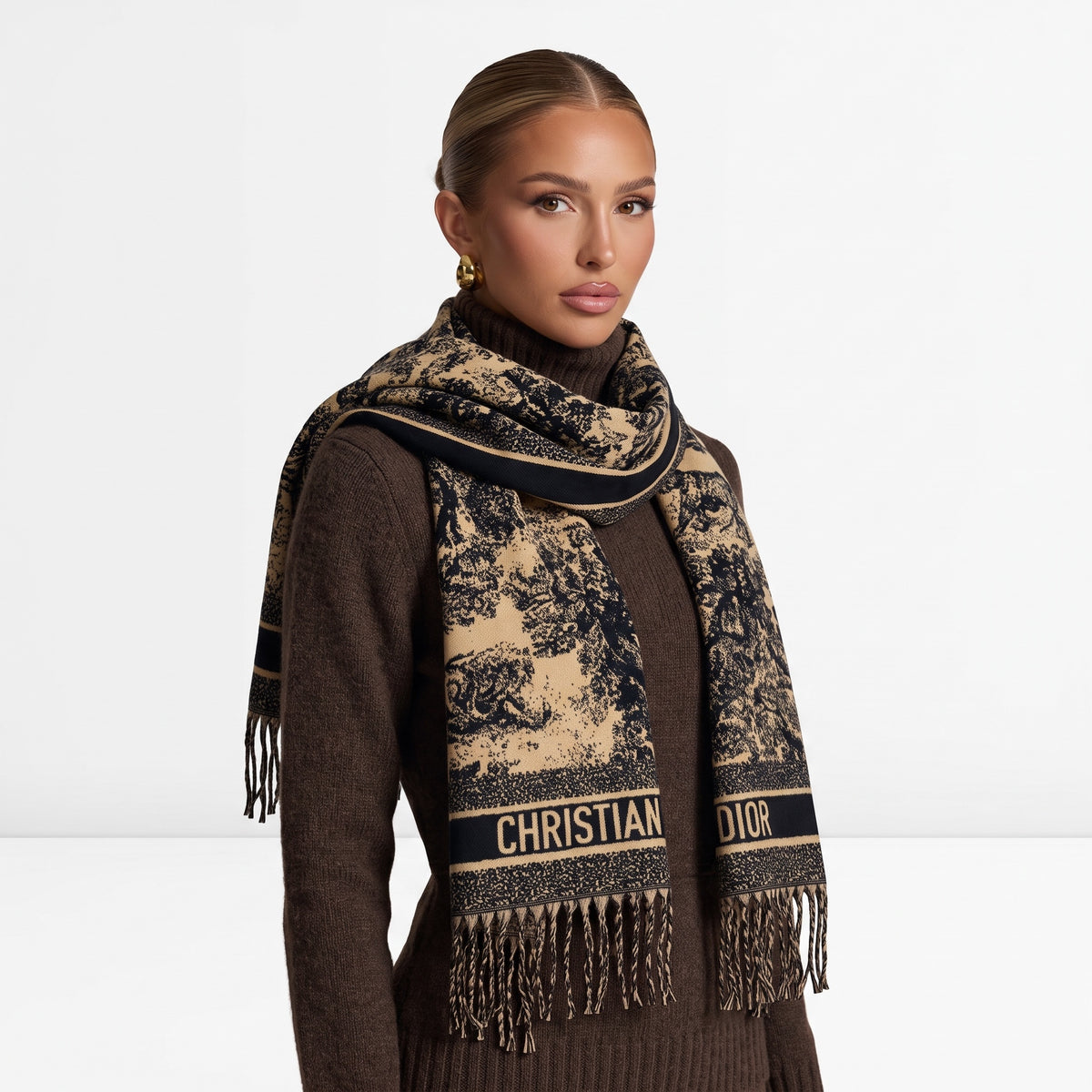 Beige and black Christian Dior logo scarf with fringed ends draped over a model