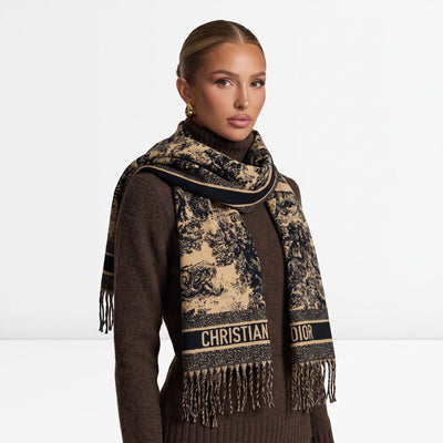 Beige and black Christian Dior logo scarf with fringed ends draped over a model