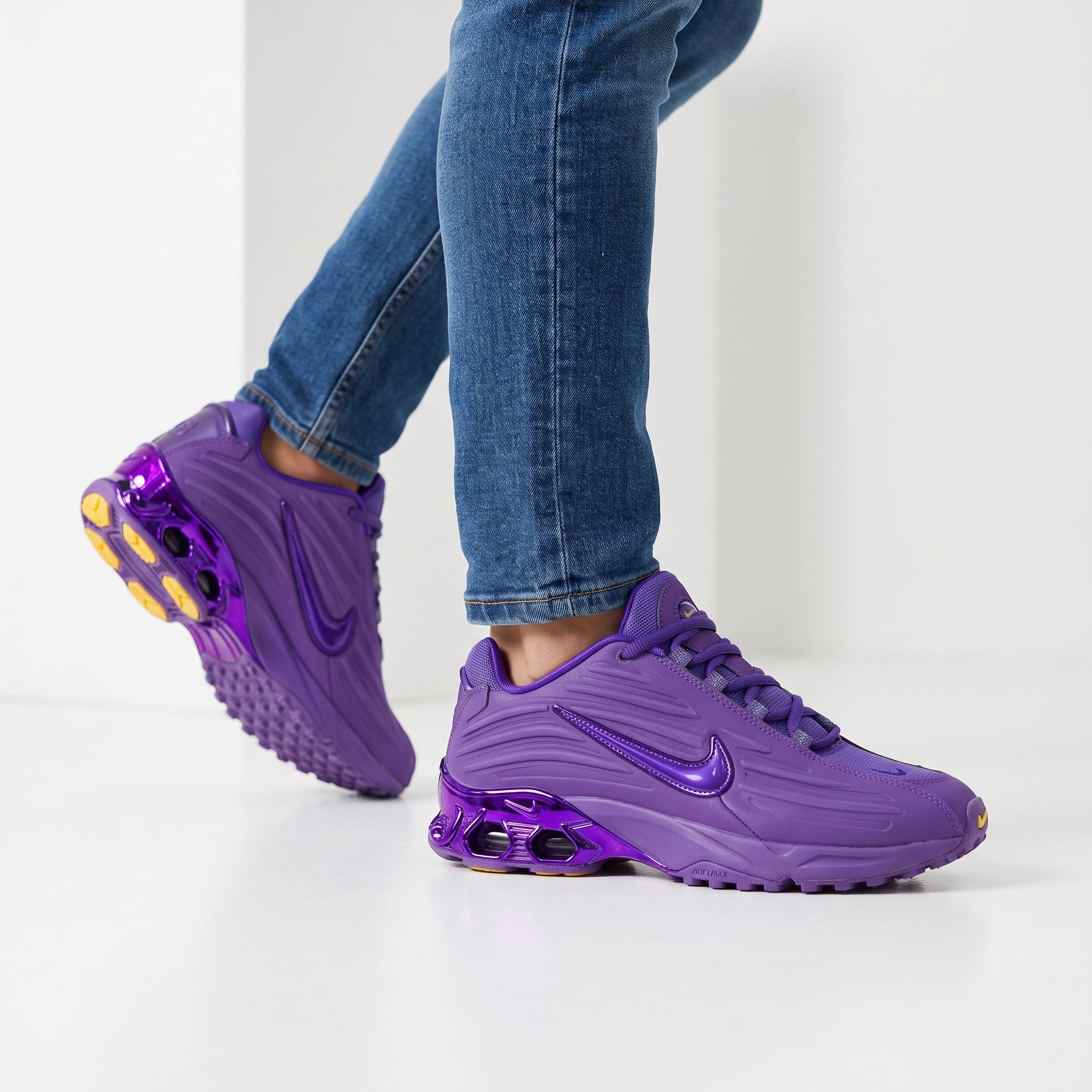 Pair of bright purple Nike sneakers with visible rear cushioning and glossy swoosh