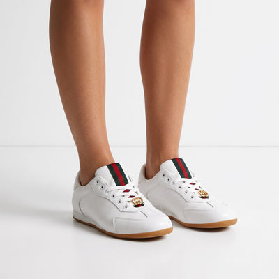 white low-top Gucci Ace sneakers with green red webstripe and gold GG on gum sole