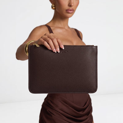 Coach pebbled leather zip pouch in dark brown with gold zipper and embossed logo