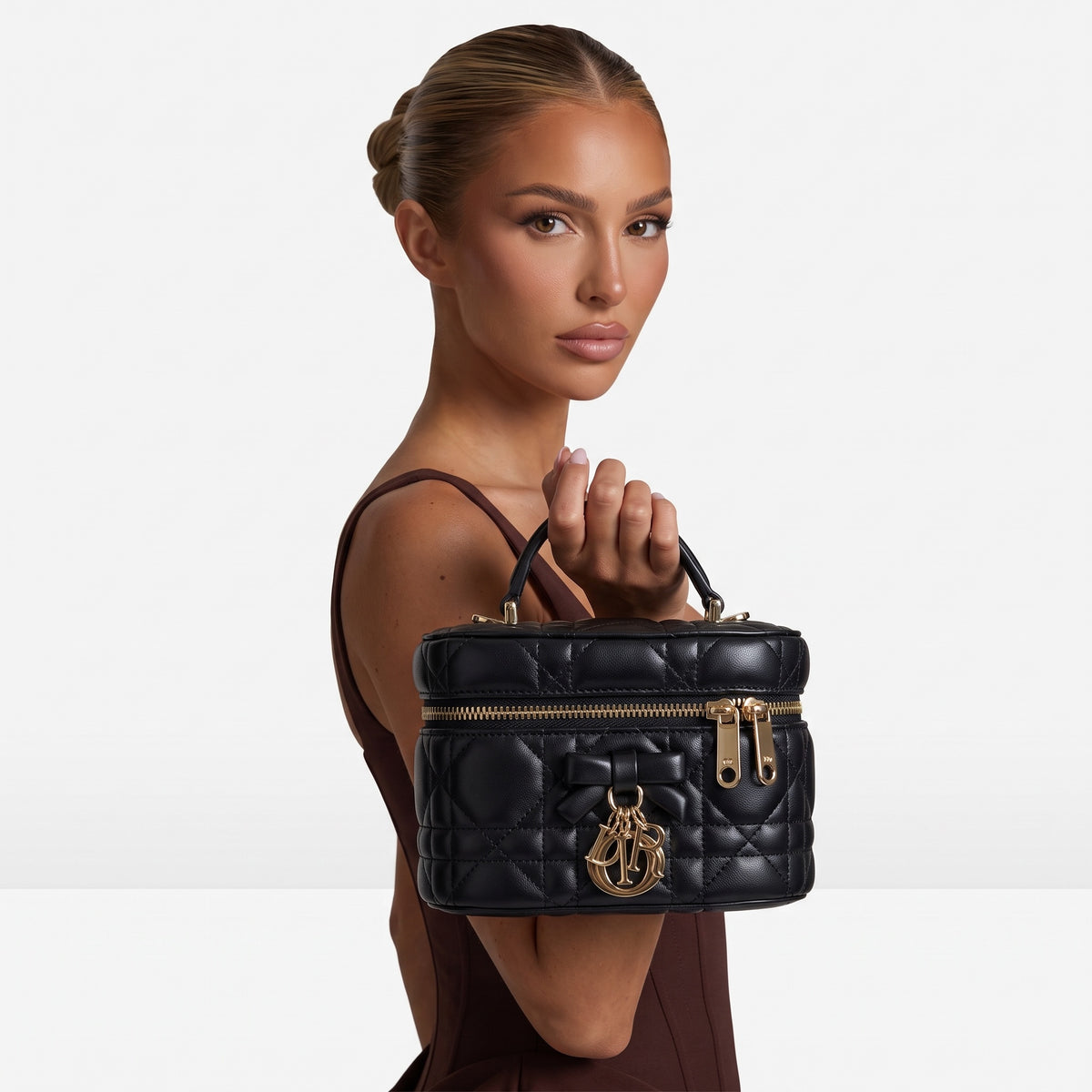 Black quilted Dior mini vanity case with top handle and gold charms