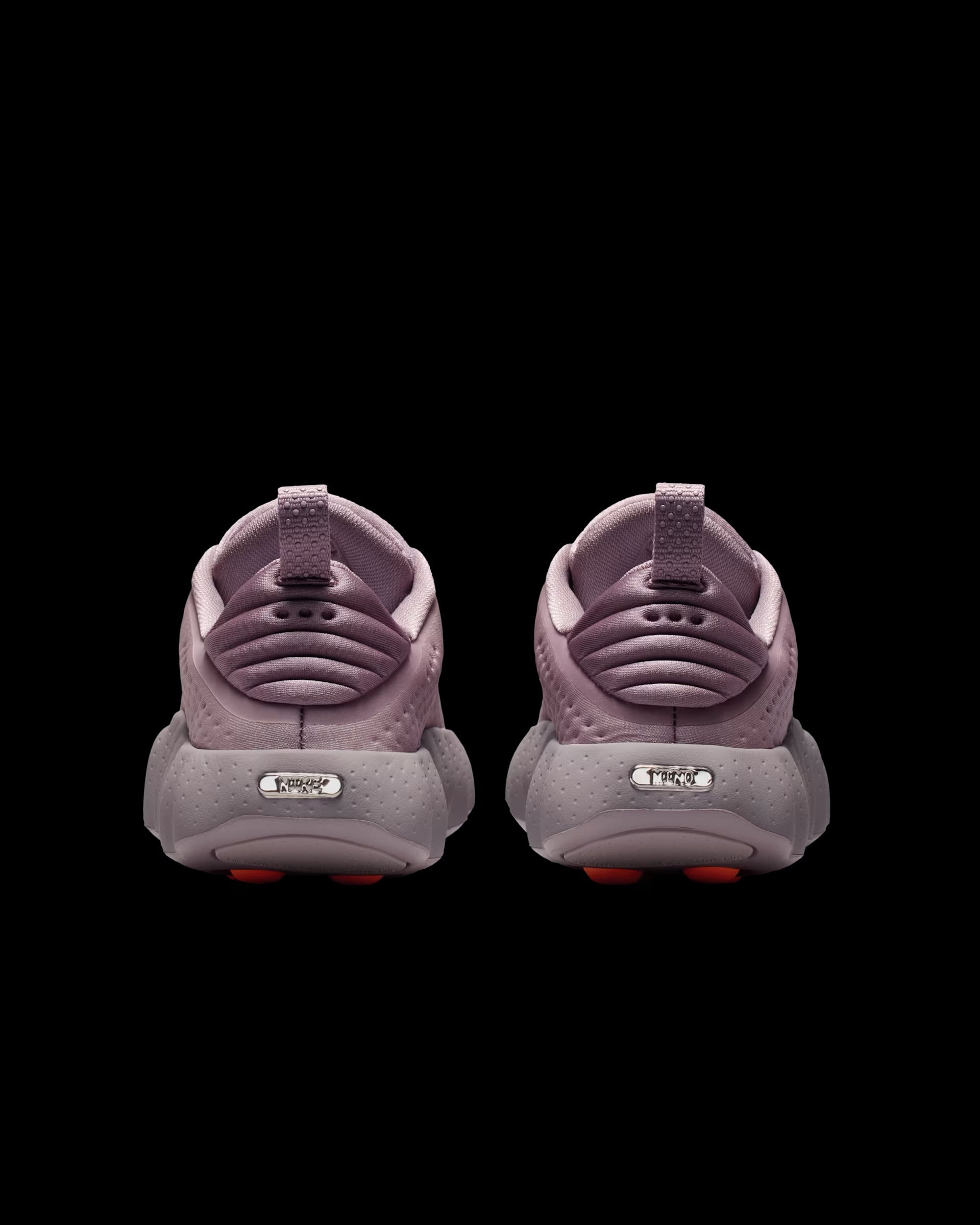 dusty pink nike sneaker with perforated upper and orange pod outsole