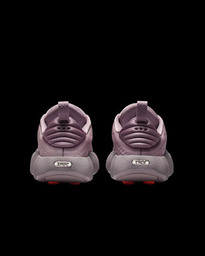 dusty pink nike sneaker with perforated upper and orange pod outsole