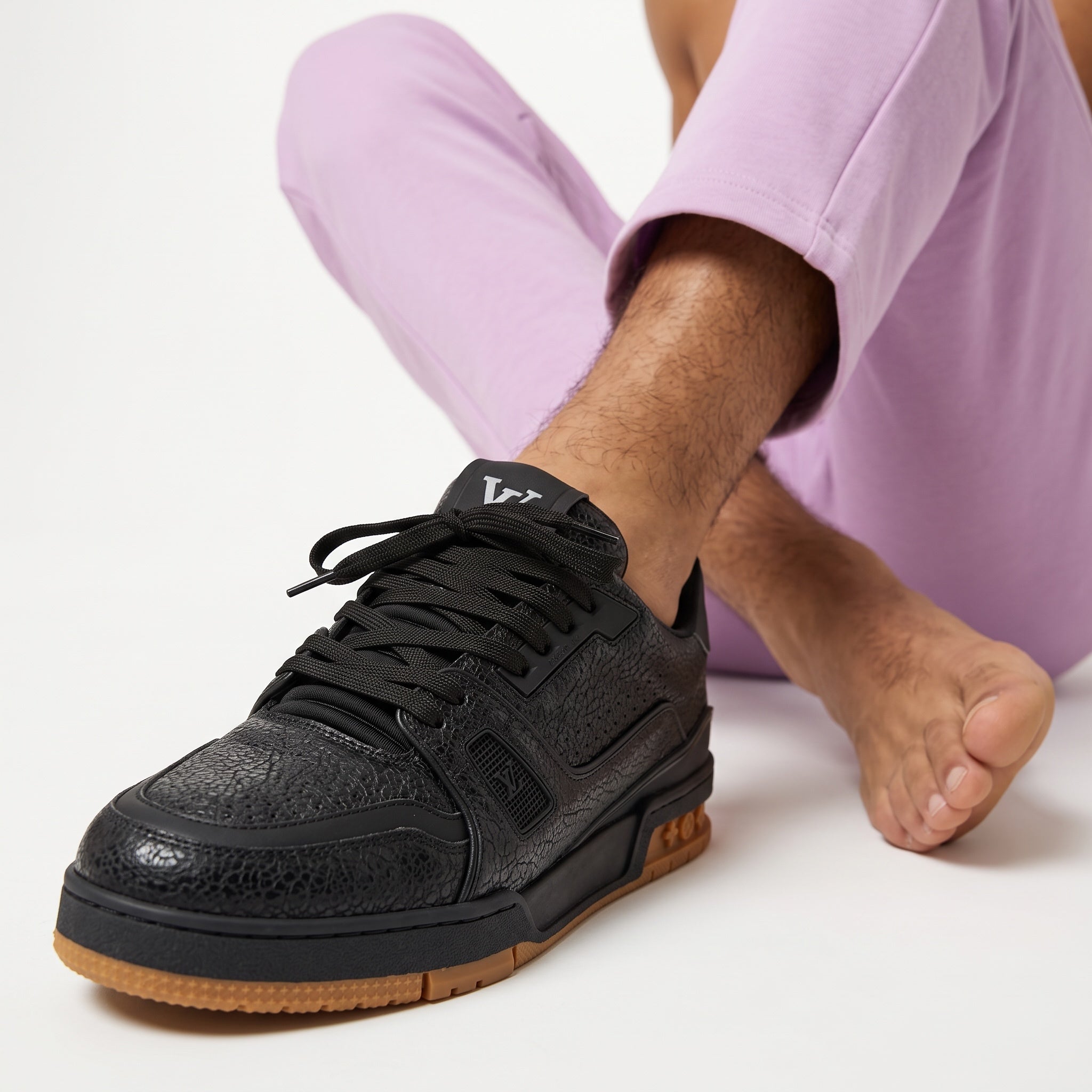 Black Louis Vuitton low-top trainer with gum sole and textured upper