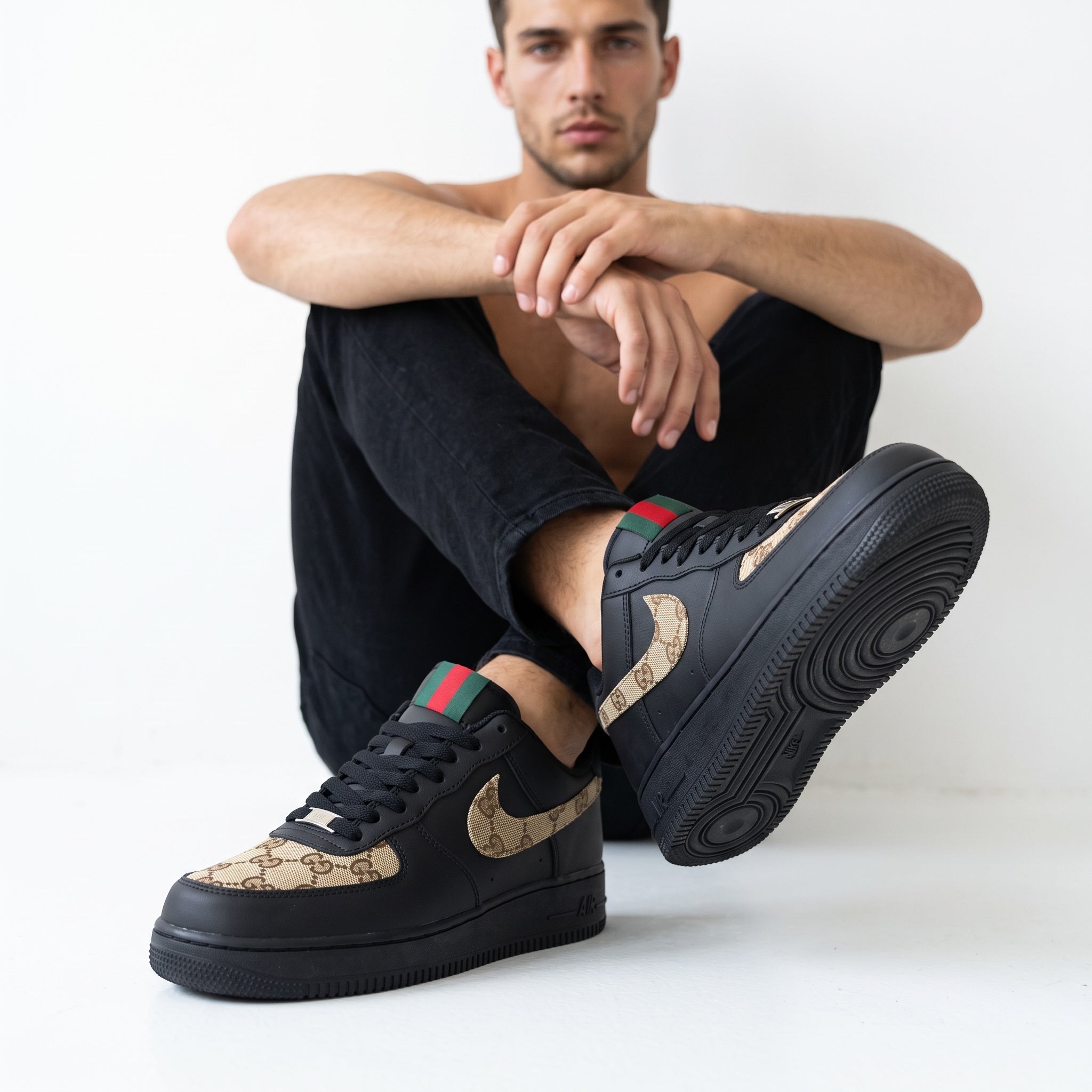 Black low-top sneakers with brown monogram Swoosh and green-red heel tab
