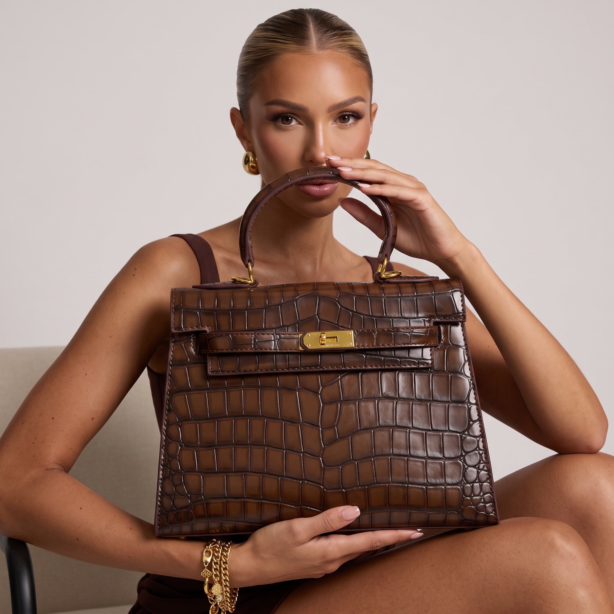 brown croc-embossed top-handle bag with gold turn-lock hardware