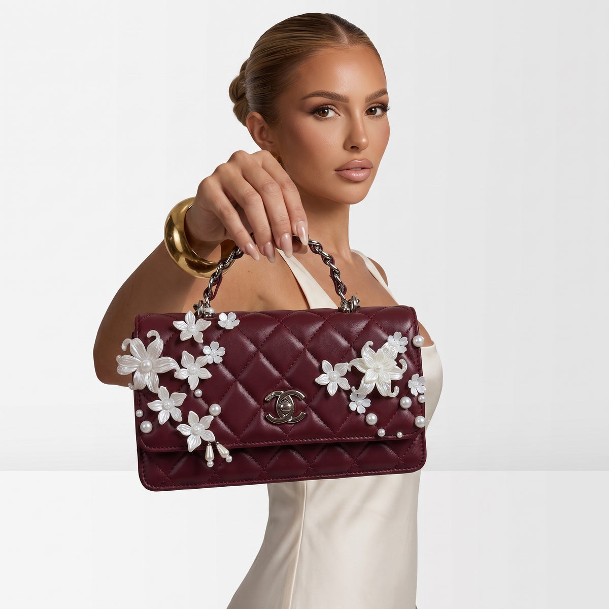 burgundy quilted Chanel top-handle flap bag with pearl floral appliqués and CC turn-lock
