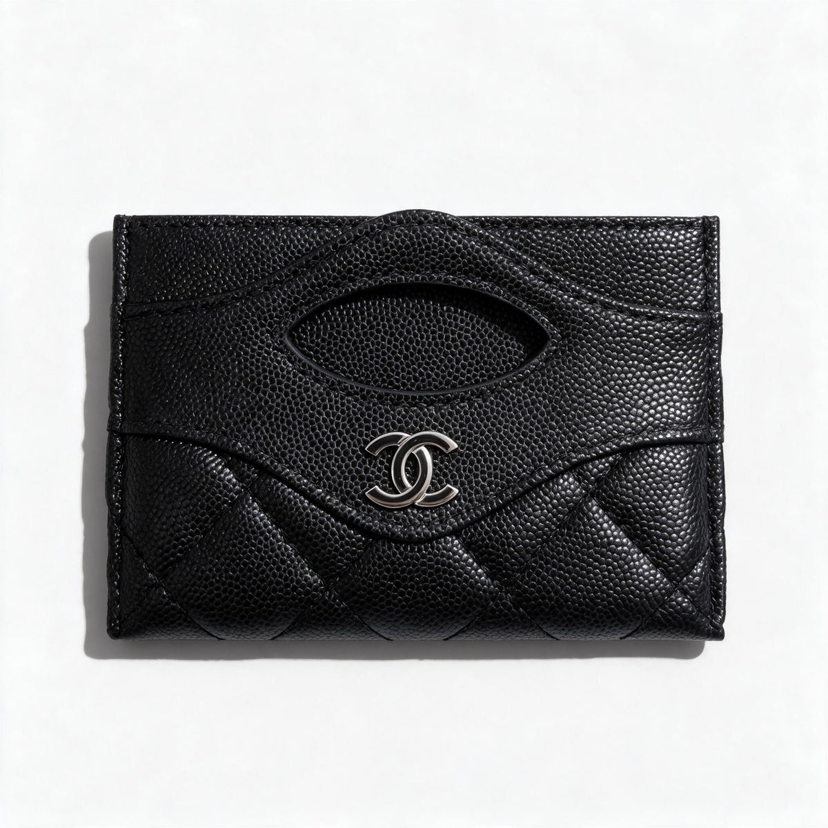 Black quilted Chanel card holder with silver CC logo and card slots