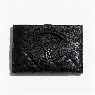 Black quilted Chanel card holder with silver CC logo and card slots