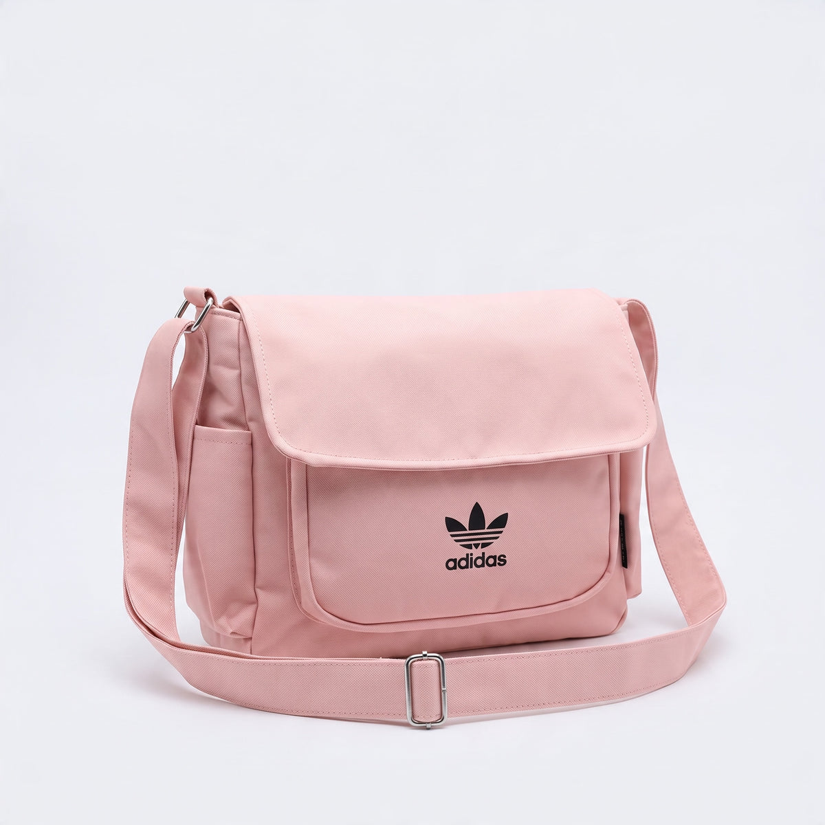 pink adidas messenger bag with trefoil logo and adjustable shoulder strap