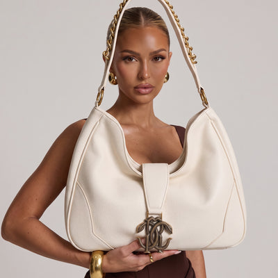Ivory pebbled Saint Laurent hobo shoulder bag with gold chain-accented strap and YSL monogram logo