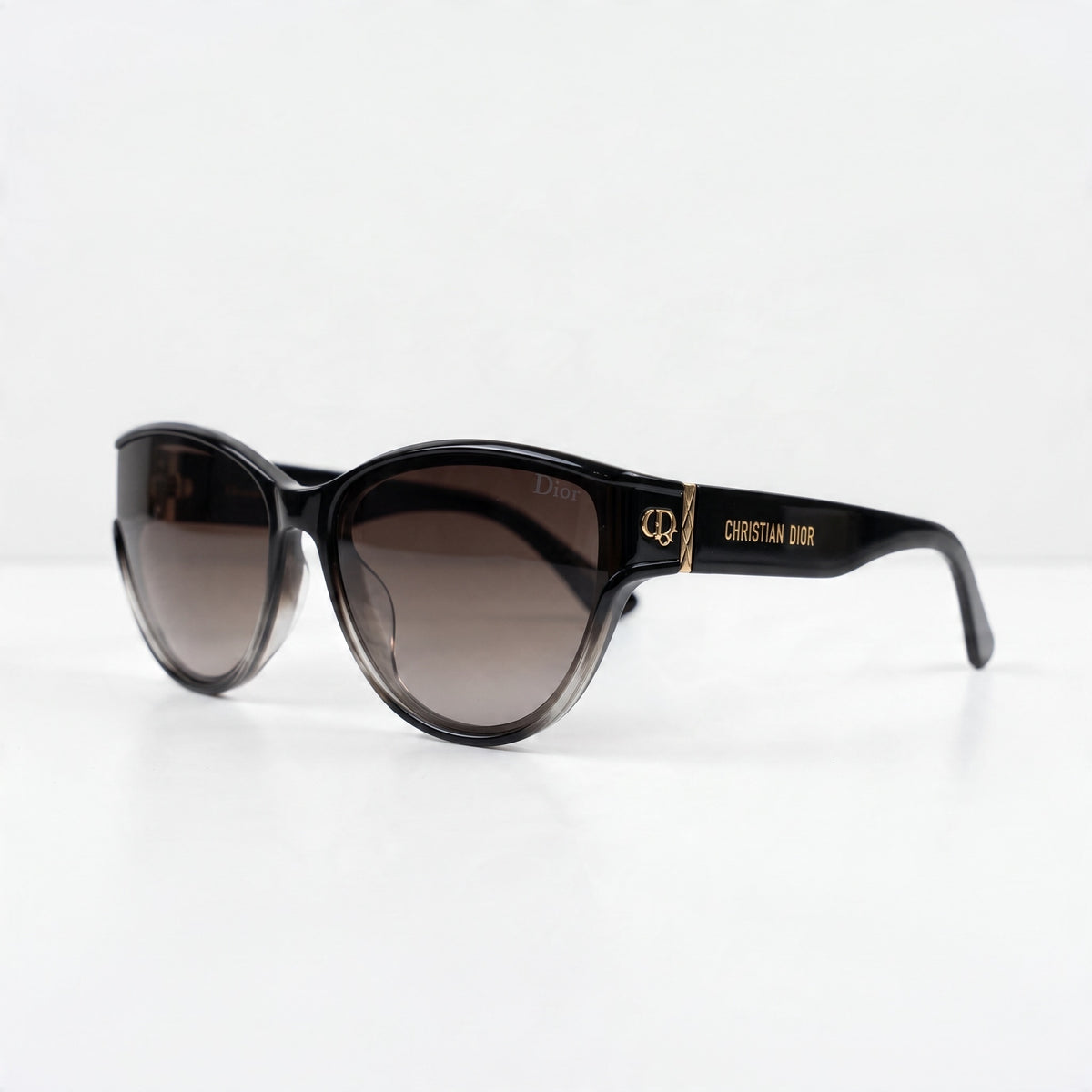 Christian Dior black oversized sunglasses with brown gradient lenses and gold logo on temple
