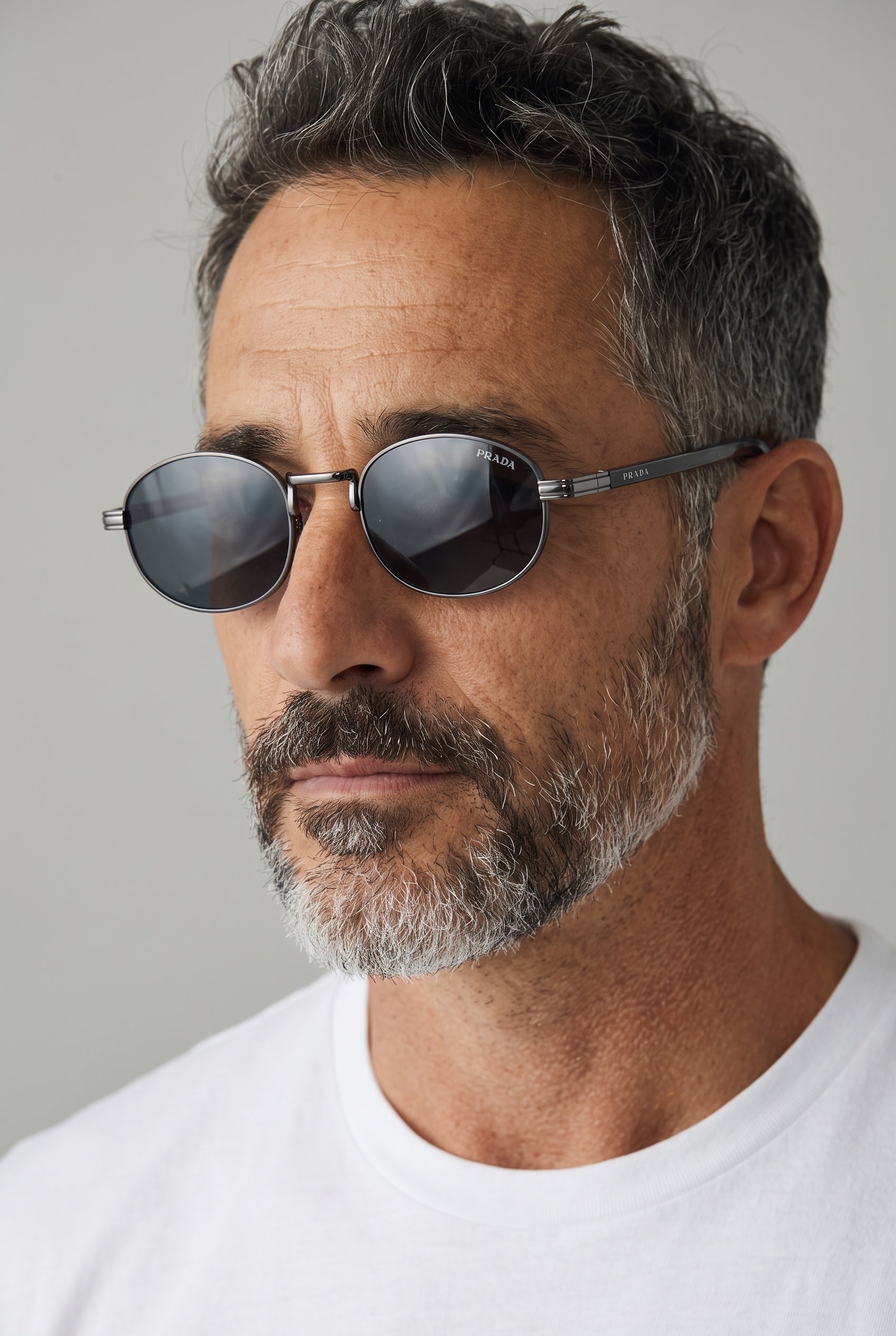 Prada round gunmetal sunglasses with dark lenses on male model