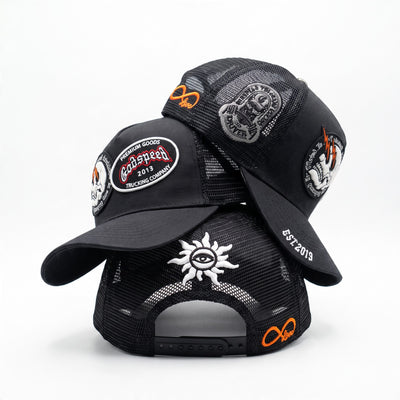 black trucker cap with multiple embroidered patches and mesh back