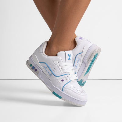 White Louis Vuitton low-top trainer with turquoise and purple accents, LV logo on tongue and embossed monogram