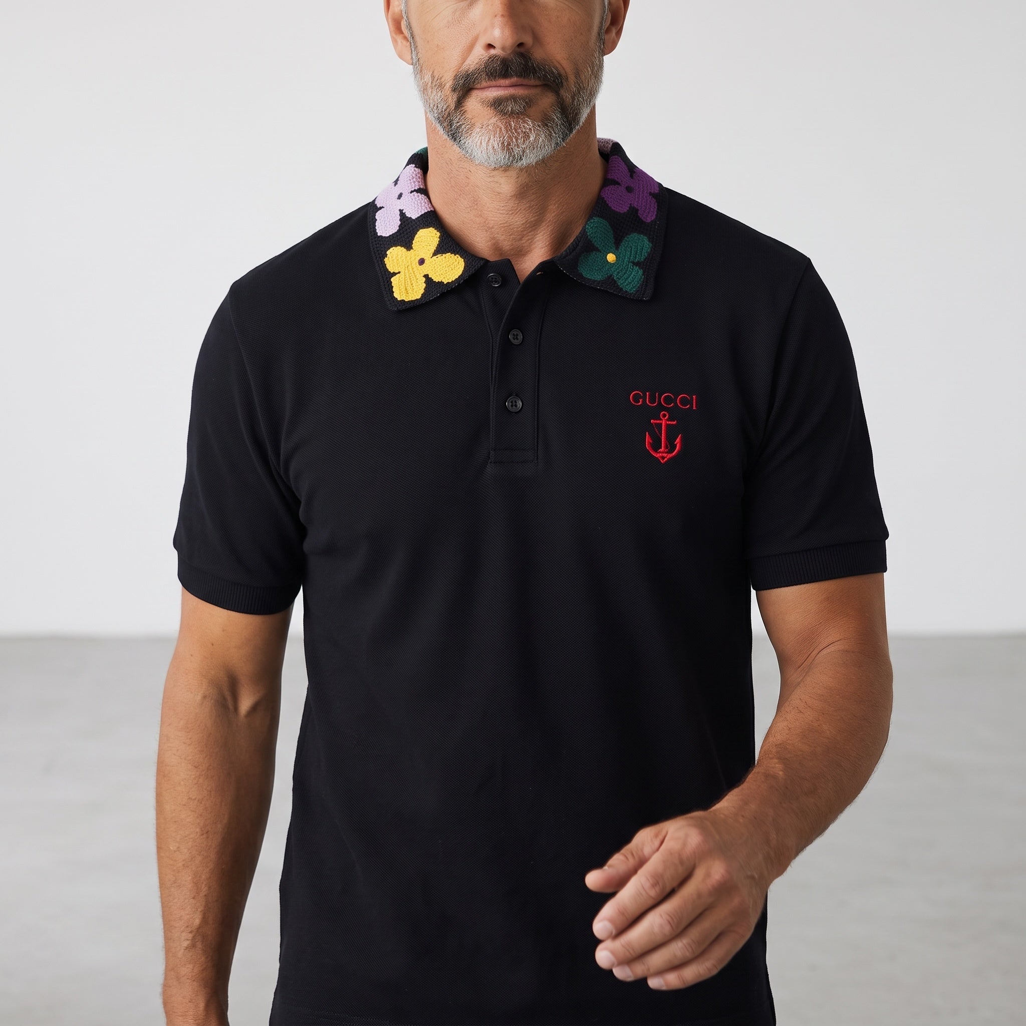 Black Gucci polo with multicolour floral knit collar and red embroidered logo