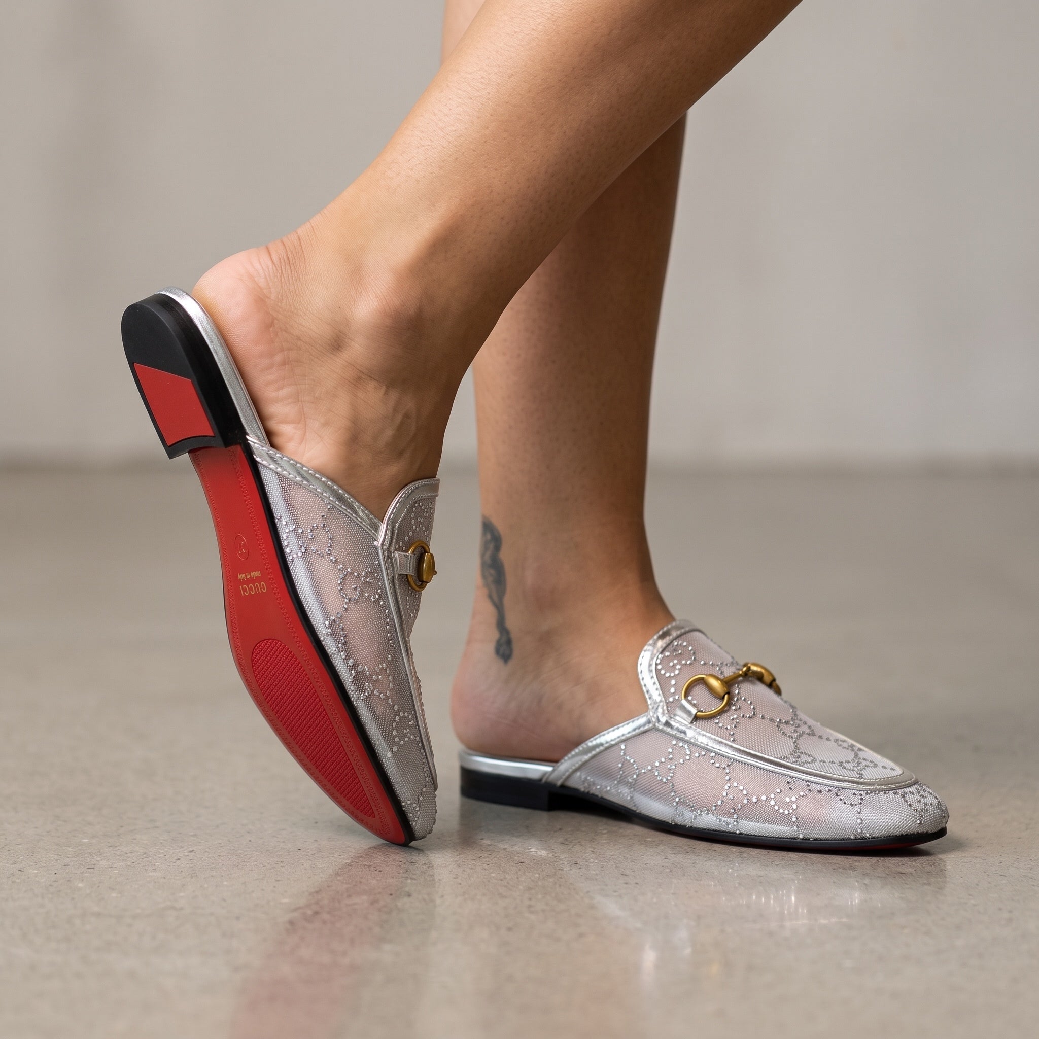 silver Gucci mesh horsebit mule with gold horsebit and red sole