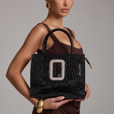 Black croc-effect patent tote bag with large crystal buckle and round top handles