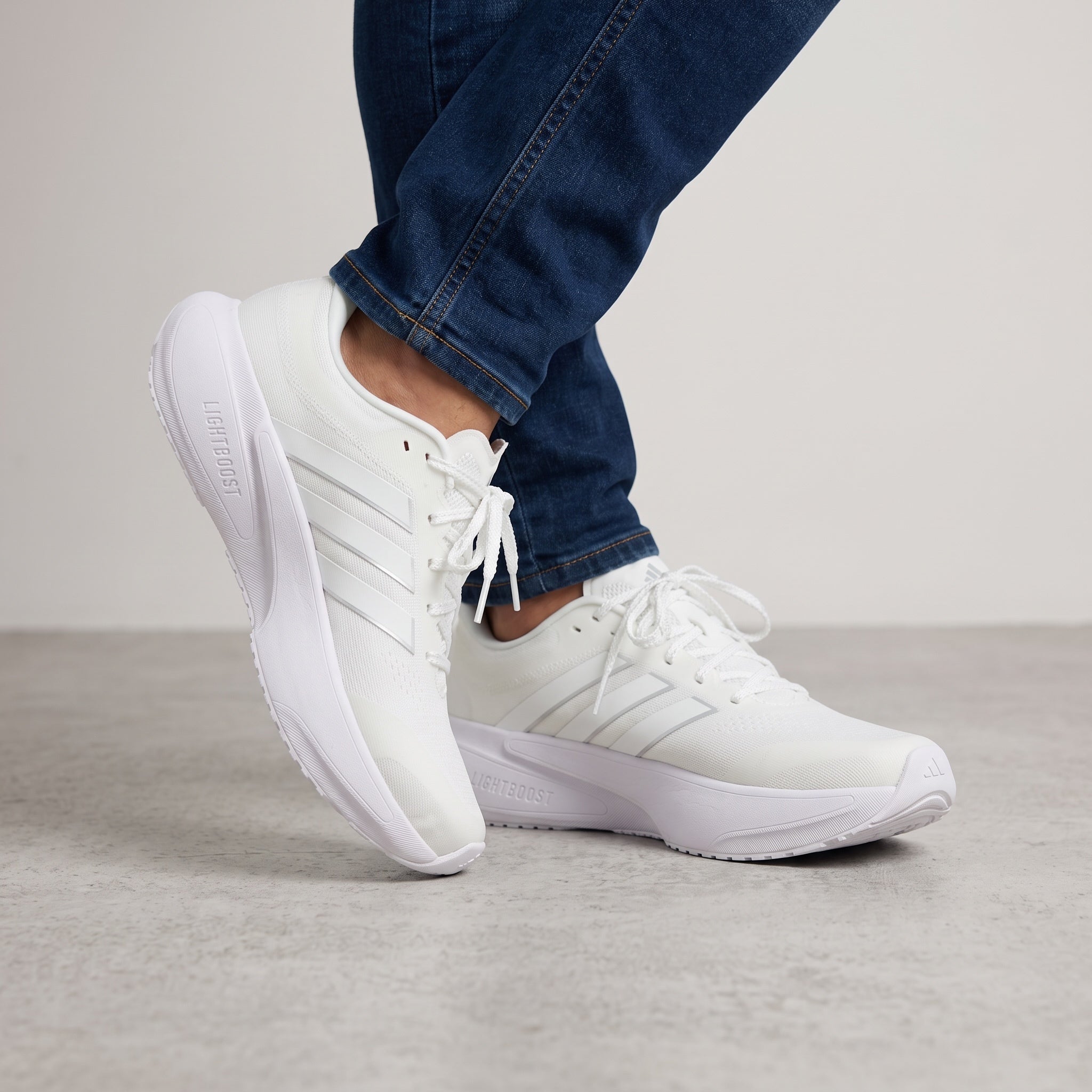 All‑white Adidas low-cut sneakers with chunky sole and three stripes
