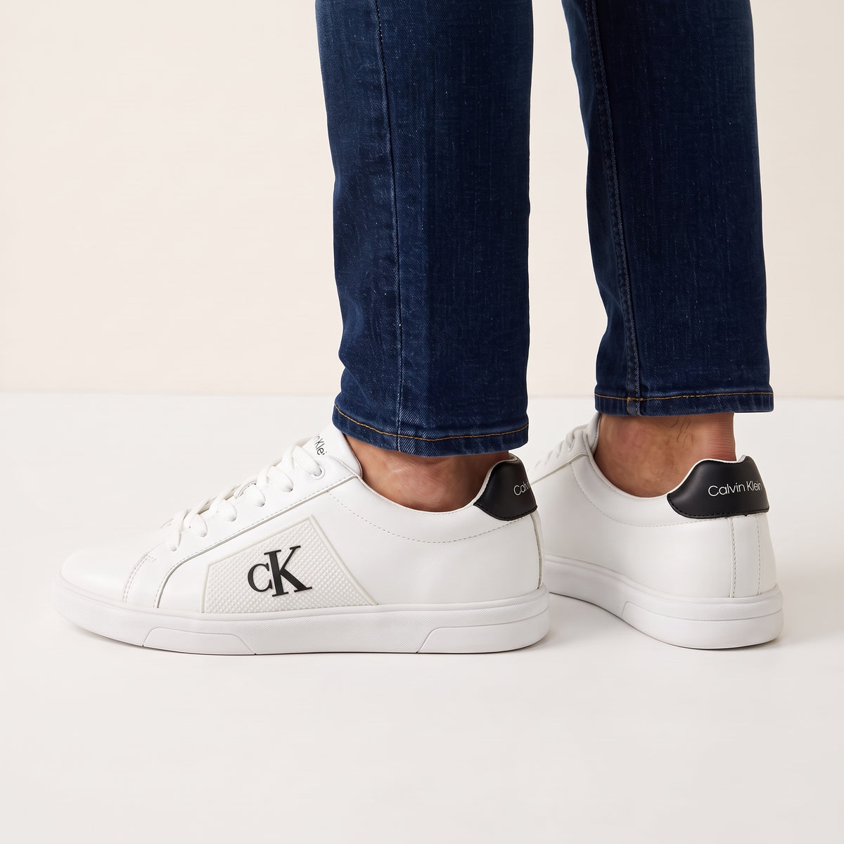 Calvin Klein white low-top sneakers with black heel tab and cK logo