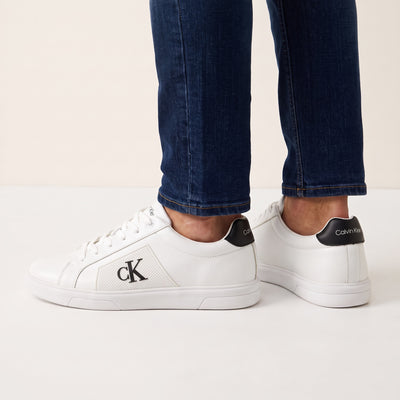 Calvin Klein white low-top sneakers with black heel tab and cK logo