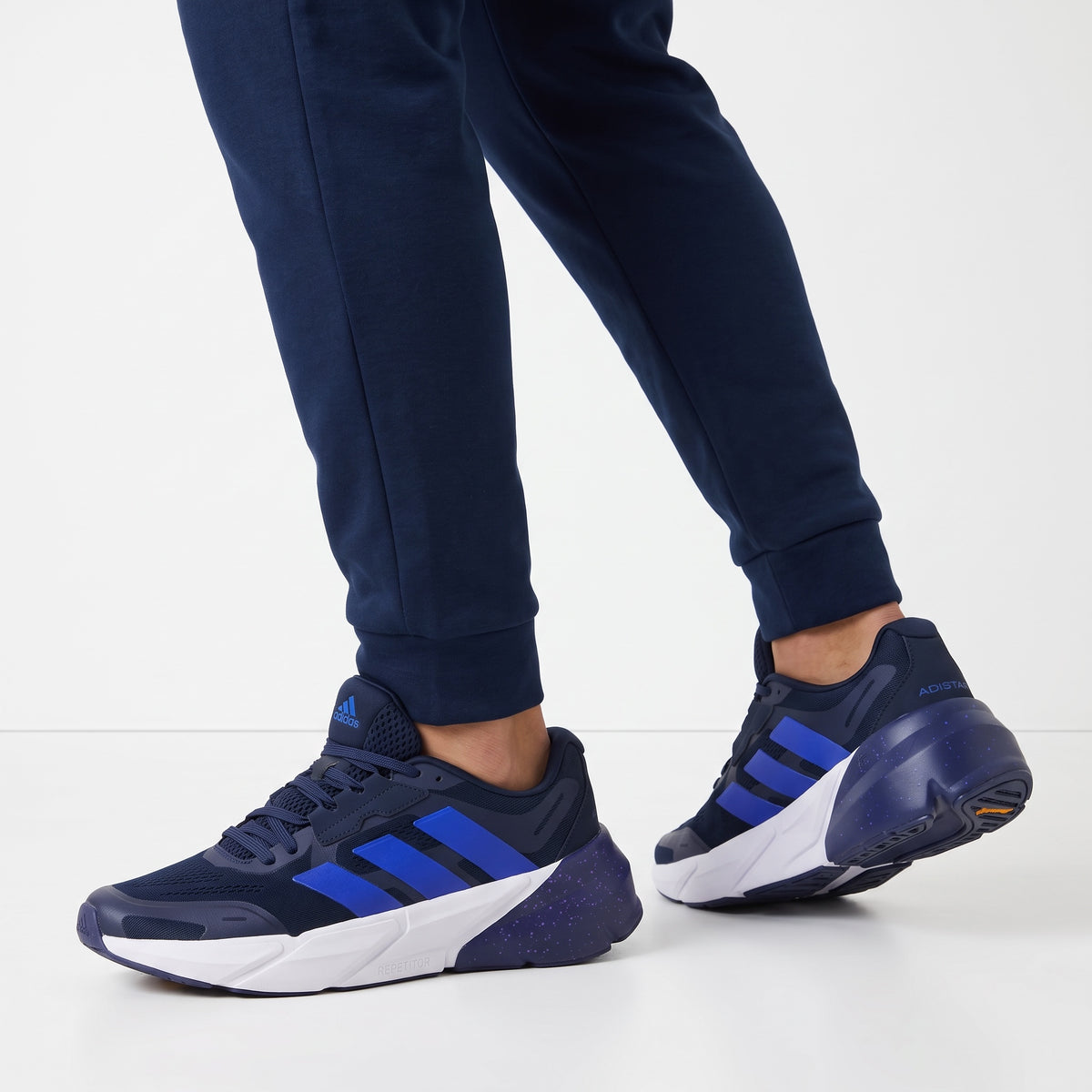 navy adidas chunky trainers with blue stripes and speckled sole