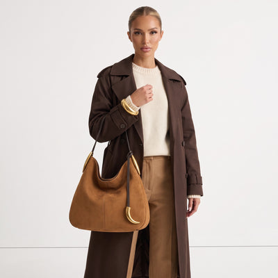 tan hobo bag with gold crescent hardware and single shoulder strap