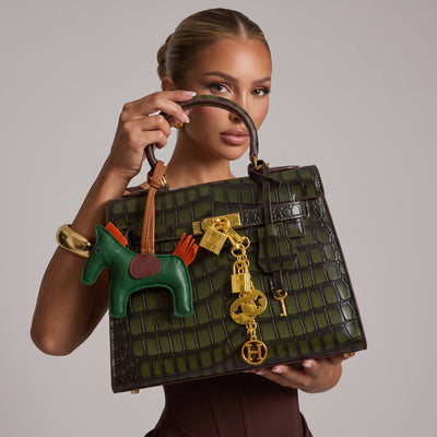 Green croc-effect Hermès Kelly style top-handle bag with gold hardware and green leather charm