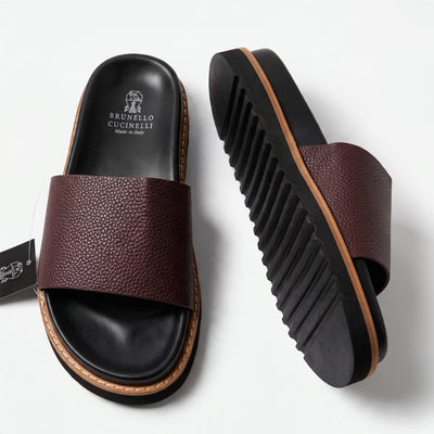 Brunello Cucinelli burgundy pebbled slide with black footbed and serrated sole