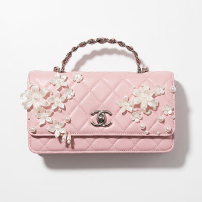 pink Chanel quilted flap bag with floral pearl appliqués and chain strap