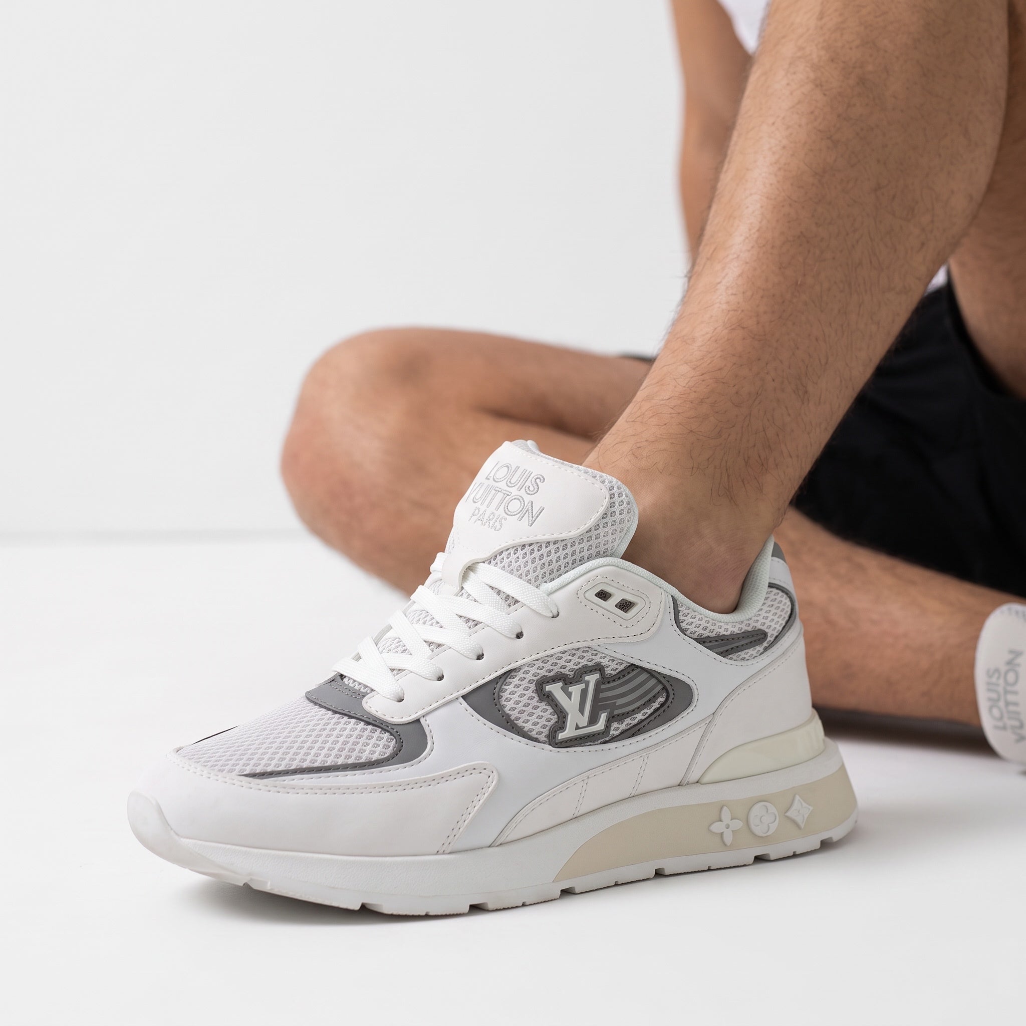 White and grey Louis Vuitton men's sneaker with LV badge and chunky sole