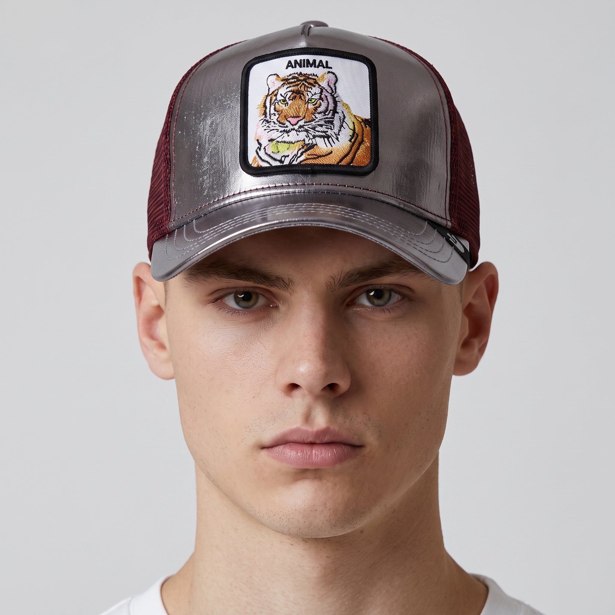 metallic silver front trucker cap with embroidered tiger patch and burgundy mesh sides