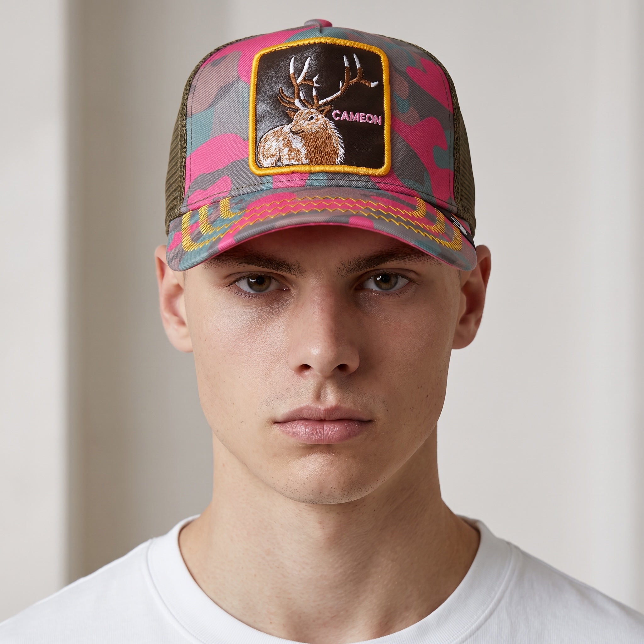 Pink camo trucker cap with embroidered deer patch and olive mesh back