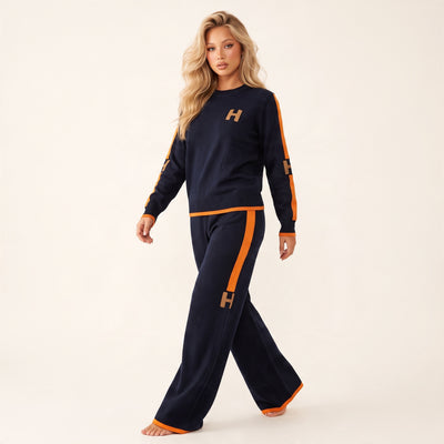 Navy knit crew top and matching wide-leg pants with orange side stripes and H logos