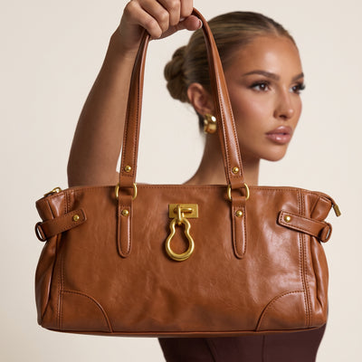 tan leather tote bag with gold hardware and double shoulder straps