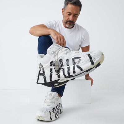 Amiri white chunky sneaker with black graffiti print and metal tag