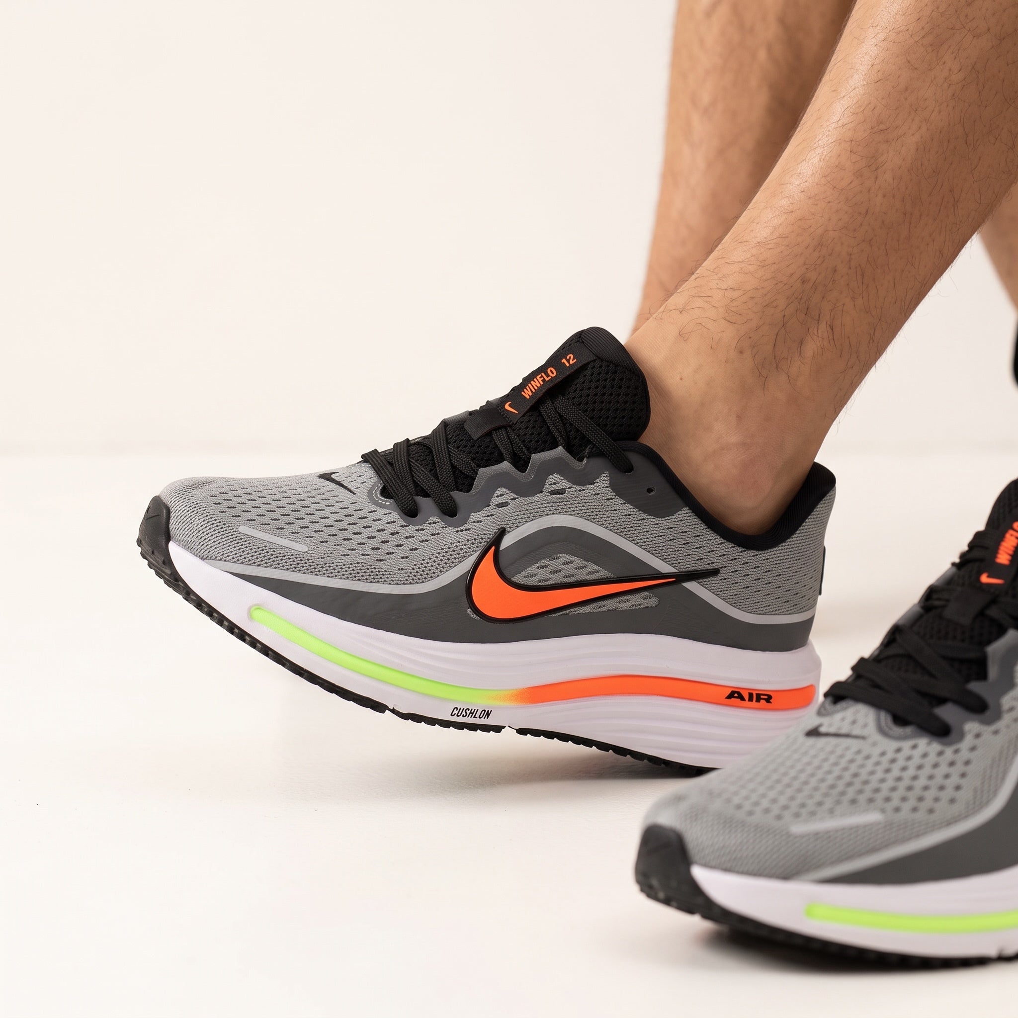 Nike Winflo 12 grey and orange running sneaker with white cushioned midsole