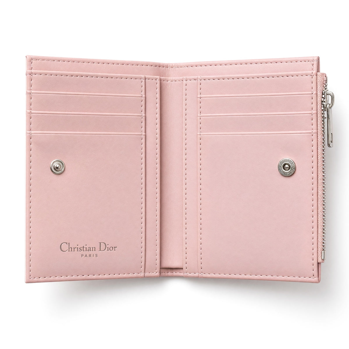 White quilted Dior compact wallet with pink bow and silver Dior charms, opened to show pink interior card slots