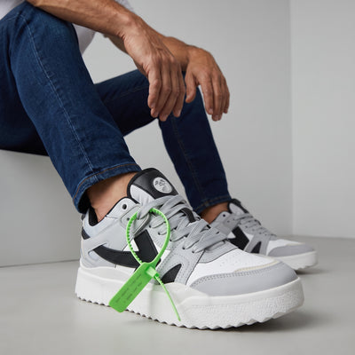Off-White x Nike grey low-top sneakers with neon green zip tie