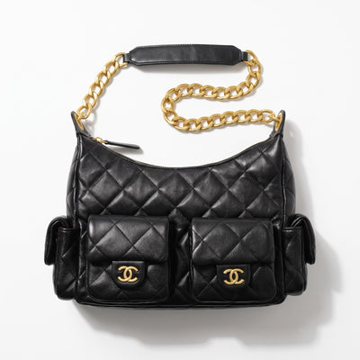 Black quilted Chanel shoulder bag with gold chain and multiple flap pockets