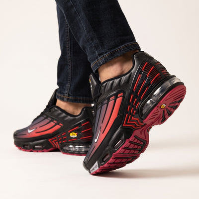 Nike Air Max Plus black and red gradient sneakers with visible Tuned Air units