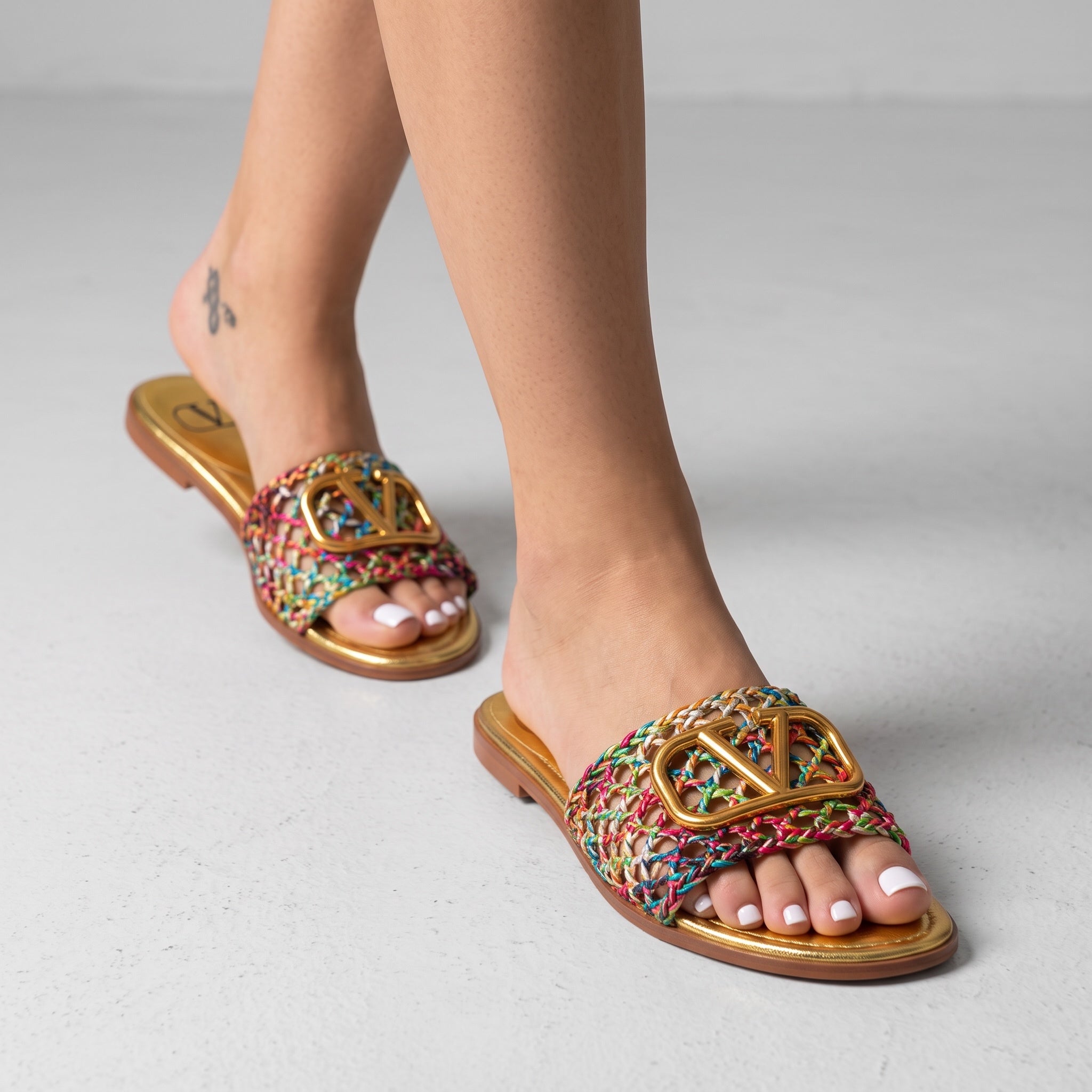 Valentino multicolor braided slides with gold V logo on gold footbed