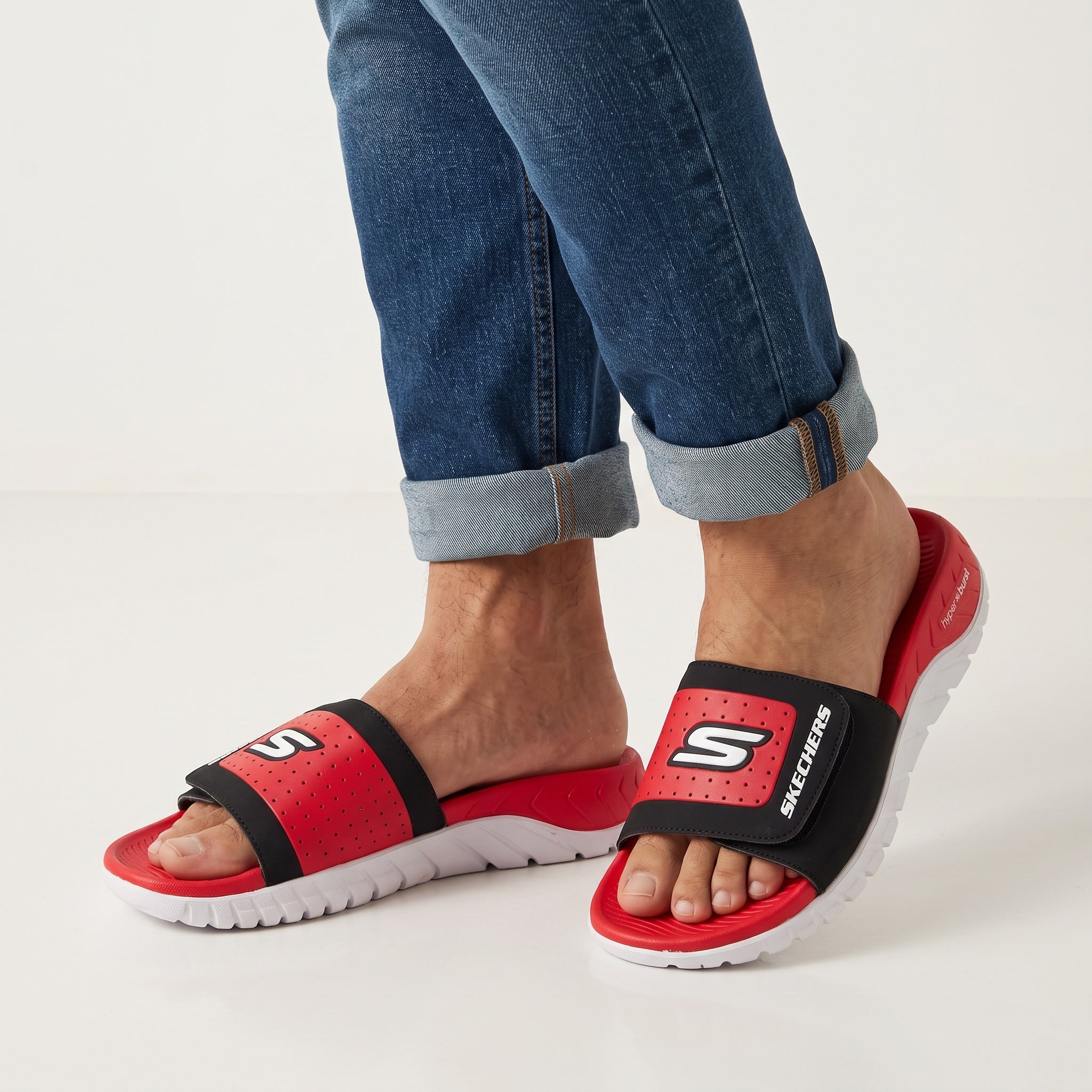 Red and black Skechers open-toe slide with white chunky sole